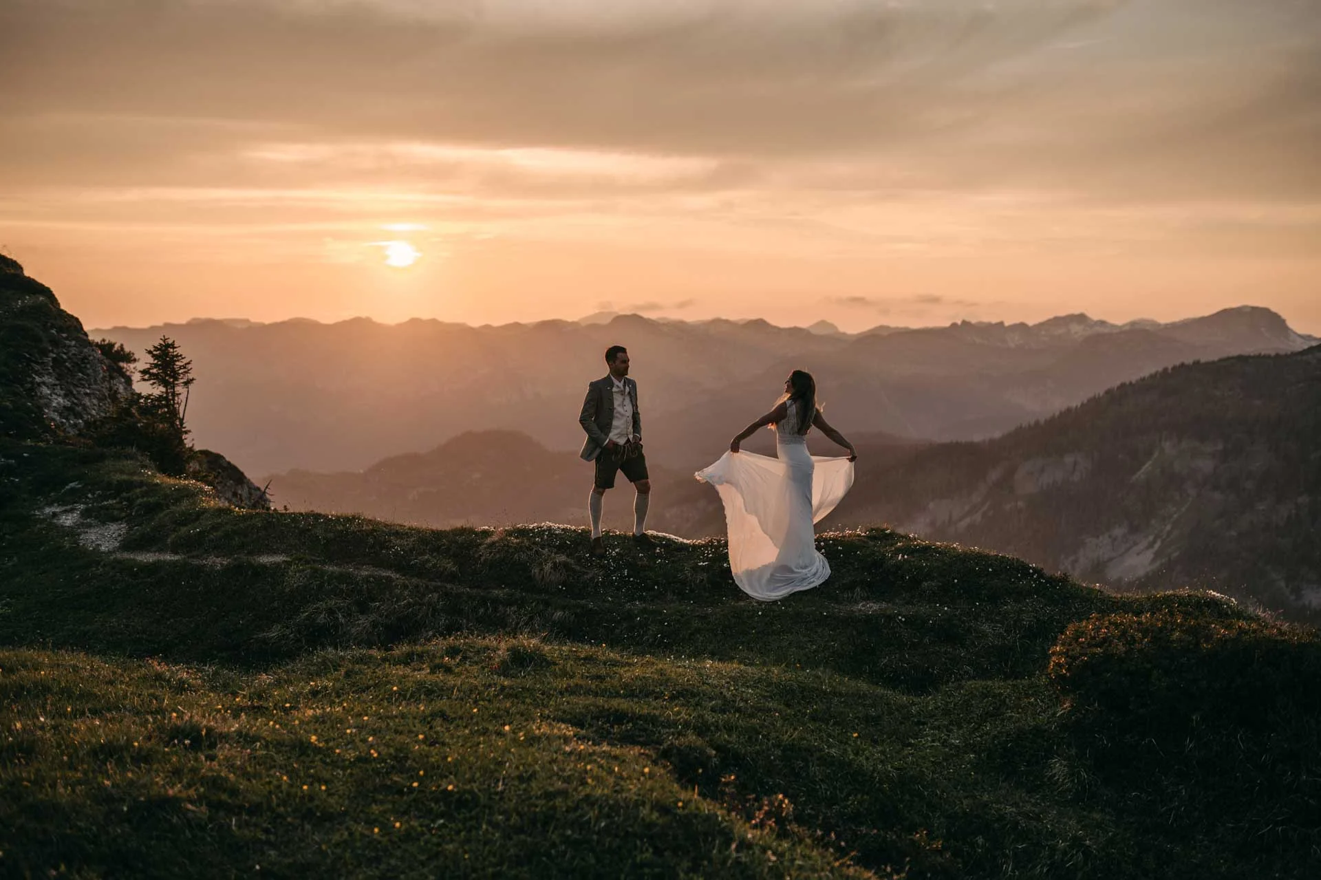 Couple at sunset on an alpine meadow