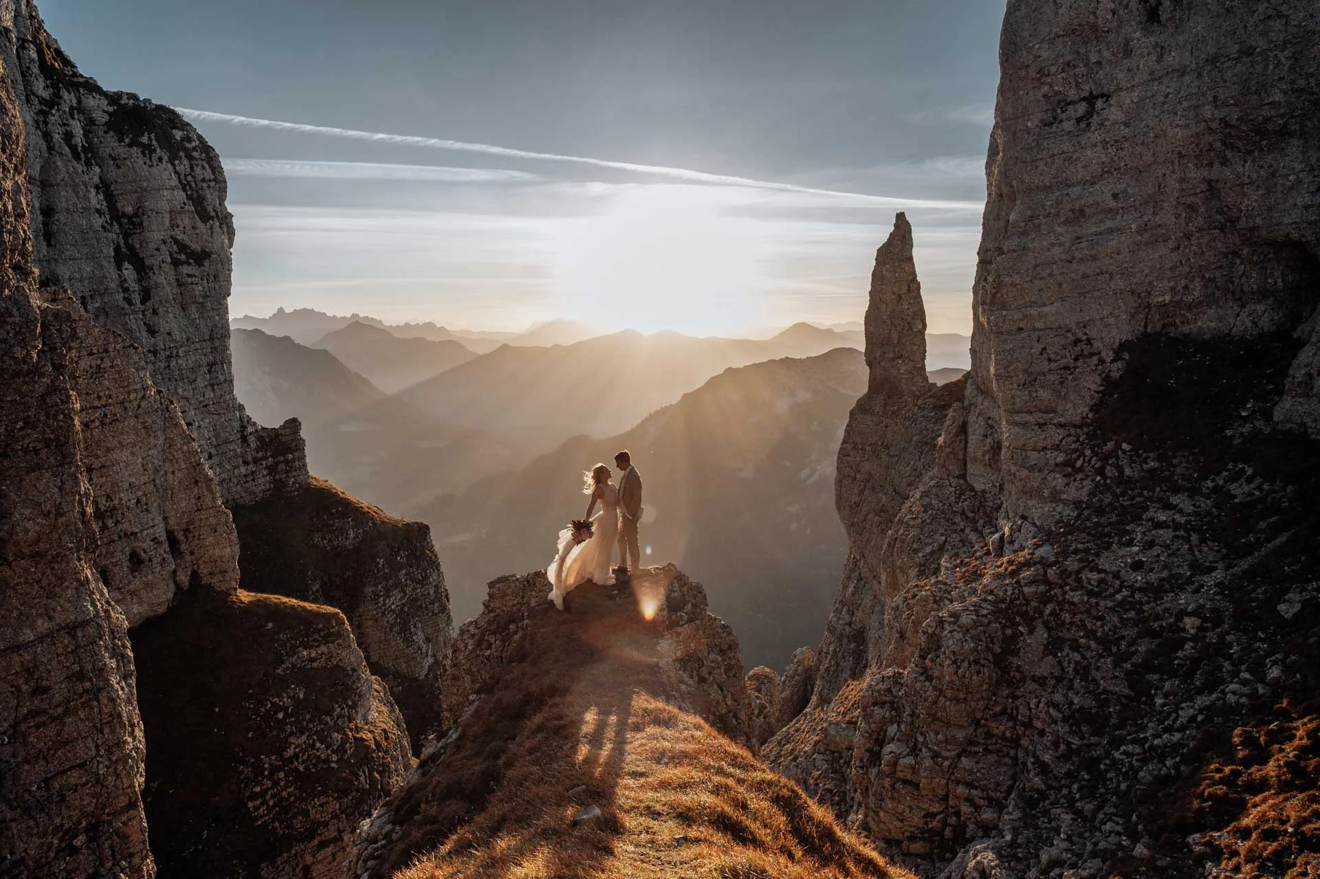 Couple on a mountain ridge between rock walls in the Alps